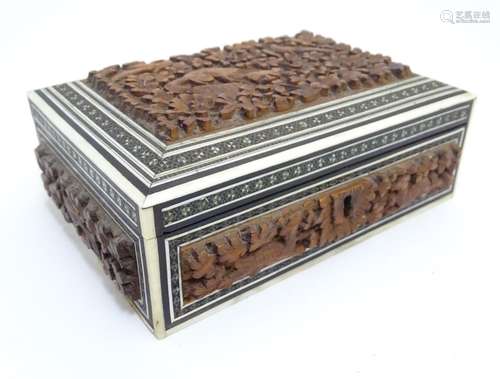 A 20thC Anglo-Indian box with carved sandalwood panels depicting animals among foliage with sadeli