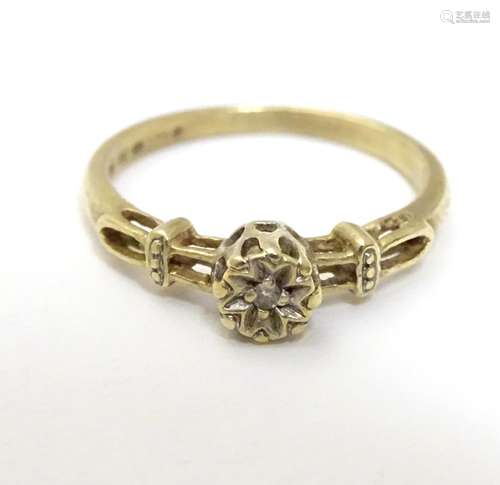 A 9ct gold ring set with central diamond. Ring size approx K Please Note - we do not make