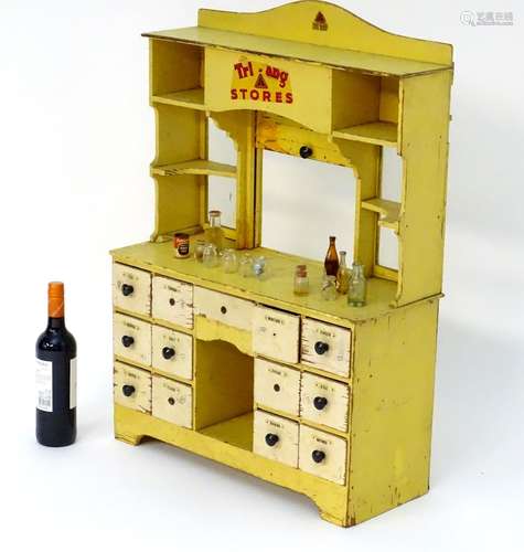 Toy: A 20thC Tri-ang Stores dresser style child's wooden play shop the bottom section with 13 fitted