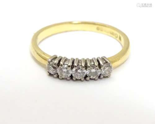 An 18ct gold ring set with 5 diamonds in a linear setting. Ring size approx. H Please Note - we do