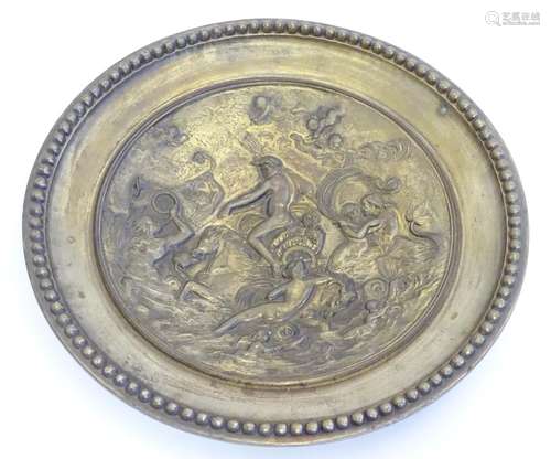 A cast decorative plate depicting the triumph of the sea god Neptune in his chariot with mermaid and