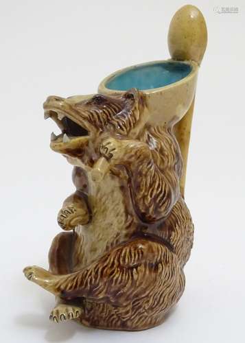 A Joseph Holdcroft majolica jug modelled as a seated bear, the handle formed as a soon. Approx. 6