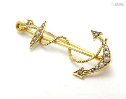 A 15ct gold brooch formed as an anchor and set with seed pearls. 1 1/4