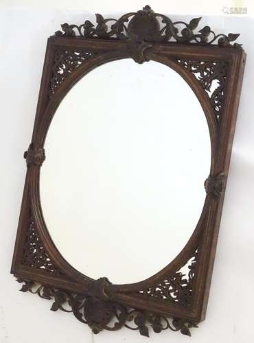 A 19thC rosewood mirror with a carved anthemion and foliate top, having pierced fretwork brackets to