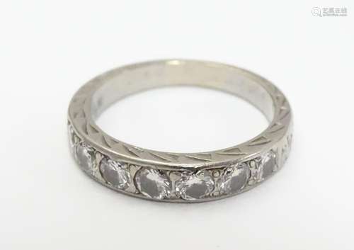 A white gold half eternity ring set with 7 graduated diamonds. Ring size approx K Please Note - we