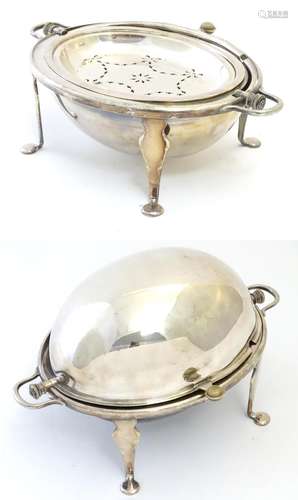 A silver plate serving dish on four feed with domed cover and grill within. Approx 14