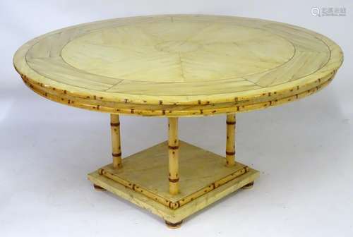 A 20thC bamboo style dining table with a well figured circular top above four turned supports and