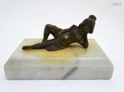 A 20thC paperweight of rectangular form, decorated with a cast model of a reclining woman on a