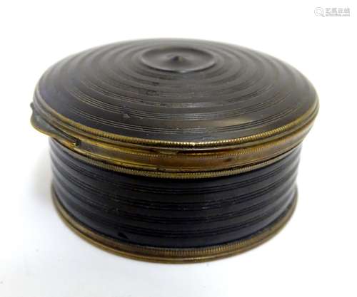 A 19thC snuff box of circular form with turned decoration with hinged lid. Approx. 1 1/4