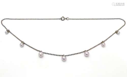 A silver necklace set with graduated pearl drops. Approx 16