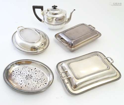 A quantity of silver plated wares comprising three tureens and a teapot. Together with a tureen base