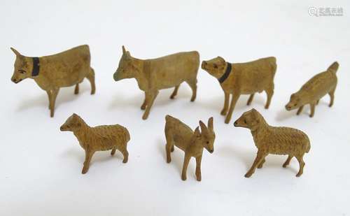 A quantity of early 20thC hand carved miniature wooden animals to include cows, sheep, deer etc.