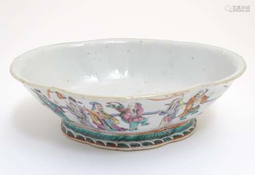 A Chinese bowl of elongated quatrefoil form decorated with sage figures and attendants in a