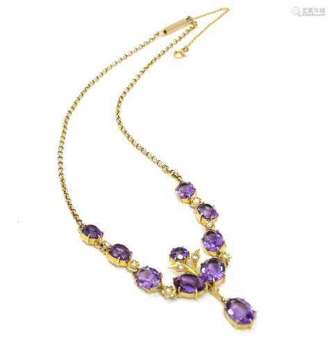 A 9ct gold drop necklace set with seed pearls and a profusion of amethyst. Approx 15