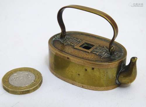 An Oriental miniature teapot / kettle with a swing handle, the top and base modelled from 100 Mon