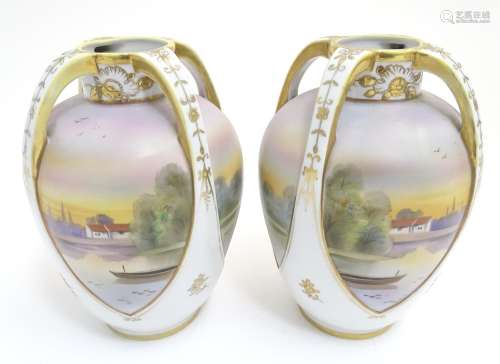 A pair of Japanese Noritake three handled vases with gilt highlights, the body decorated with sunset