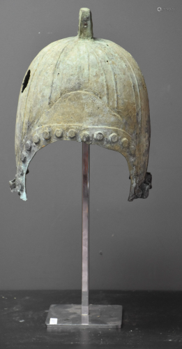 Antique warrior helmet with green and gray patina.