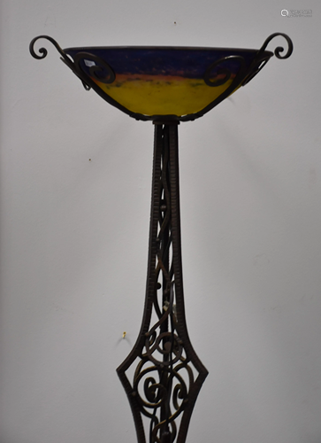 Art deco wrought iron floor lamp topped with a glass