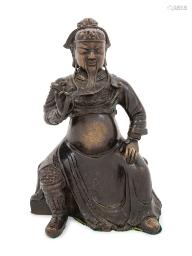 A Chinese Bronze Figure of a Seated Guardi…