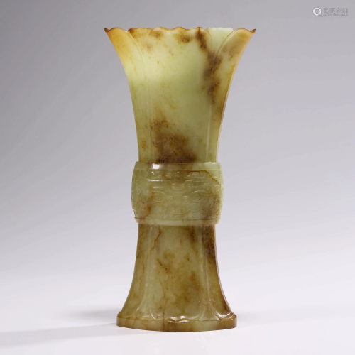 A YELLOW JADE ARCHIASTIC VASE WITH T…