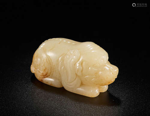 A pale green and russet jade recumbent mythical beast Yuan/Ming Dynasty