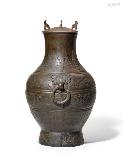 A rare archaic bronze wine vessel and cover, hu Warring States Period
