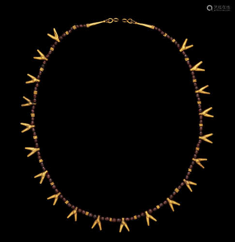 An Egyptian gold and garnet necklace with fly amulets