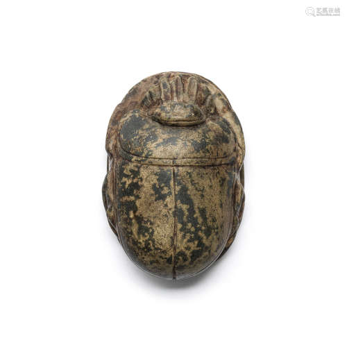 An Egyptian mottled green stone heart scarab