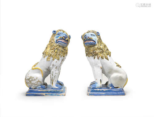 A pair of large French faience models of lions, circa 1800