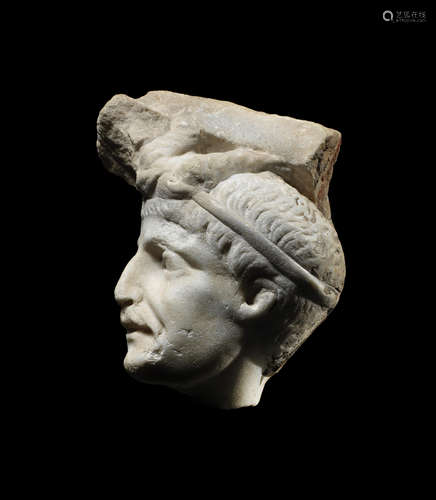 A Roman marble relief fragment with a male head