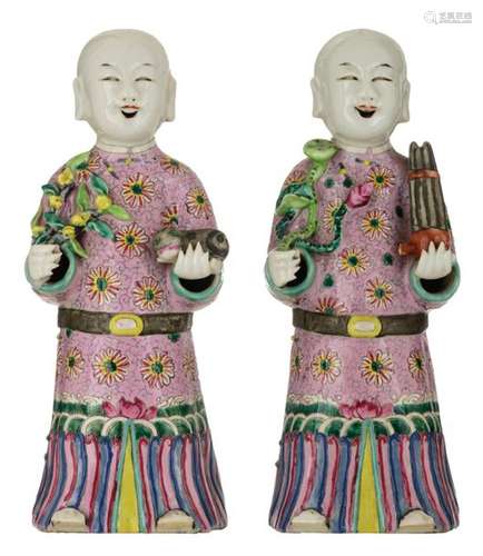 Two Chinese porcelain figures of a smiling boy, on…