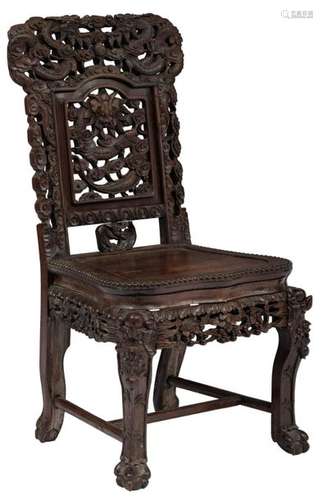 A Chinese abundantly carved exotic hardwood chair,…