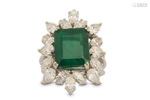 An emerald and diamond cluster ring