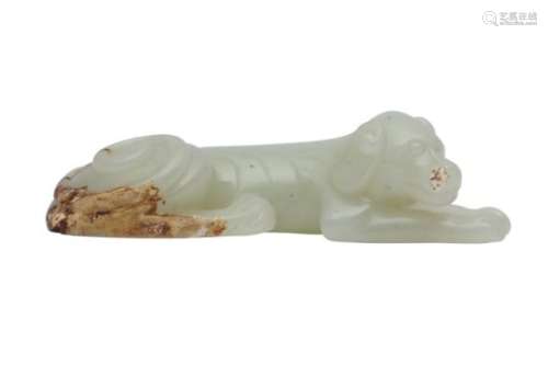 A CHINESE PALE CELADON JADE CARVING OF A DOG.