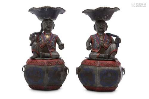 A PAIR OF CHINESE PEWTER 'BOYS' CANDLE HOLDERS.