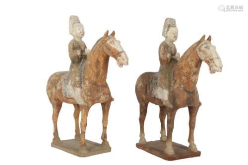 A PAIR OF CHINESE POTTERY HORSERIDERS.
