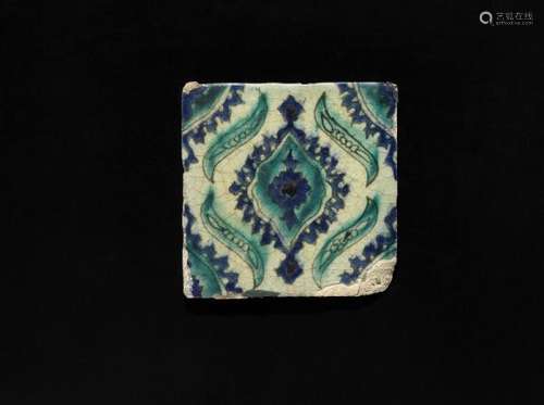 A pottery tile decorated with stylized design in blue and turquoise under transparent [...]