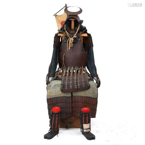 A brown/blue Japanese Gusoku suit of armour in a box with a stand. -