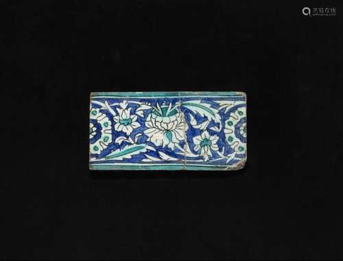 An Iznik pottery border tile, decorated in blue and turquoise on white ground with [...]