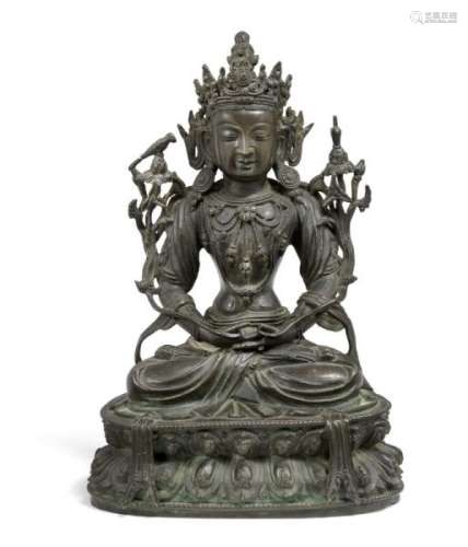 A Chinese bronze Tara, seated in dhyanasana on a double-lotus base.  Ming 1368-1644. [...]