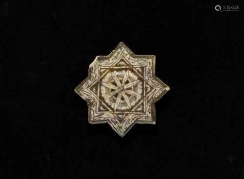 A Kashan lustre pottery star tile decorated with flowers and design. Persia. End of [...]