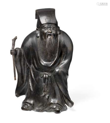 A Chinese patinated bronze figure of a Daoist Immortal. Late Ming/early Qing. Weight [...]