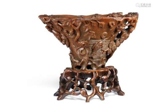 A Chinese rhinoceros carved cup. With pierced wooden stand. 17th-18th century. Weight [...]