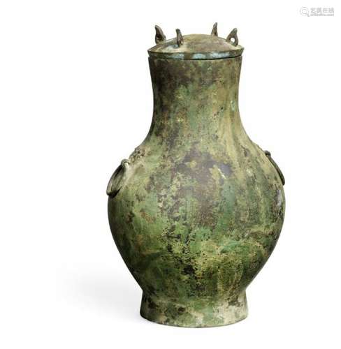 A Chinese bronze ceremonial wine vessel and cover, hu. Han dynasty. Weight 2007 g. H. [...]