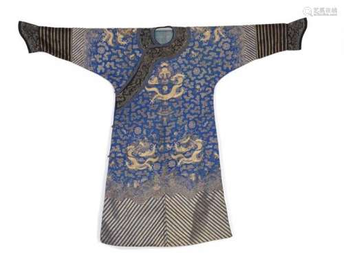 A Chinese blue and black semi-formal silk court robe. 19th century. L. 143 cm.  -