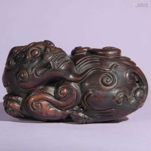 A Red Sandalwood Carved Kylin Shaped Paper Weight