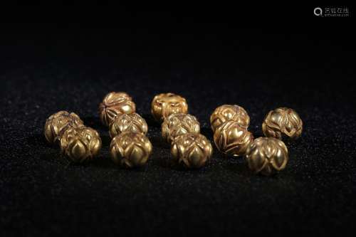 A Set of 12 Gold Beads