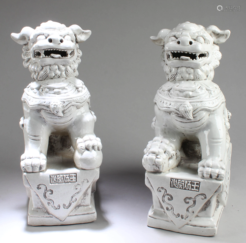 A Pair of Chinese Blanc De Chine Foo Dog Statues