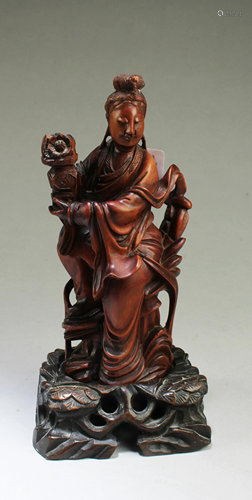 A Carved Wooden Guanyin Figurine