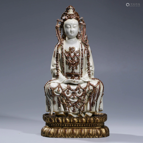A COPPER RED PORCELAIN GUAN YIN WITH STAND